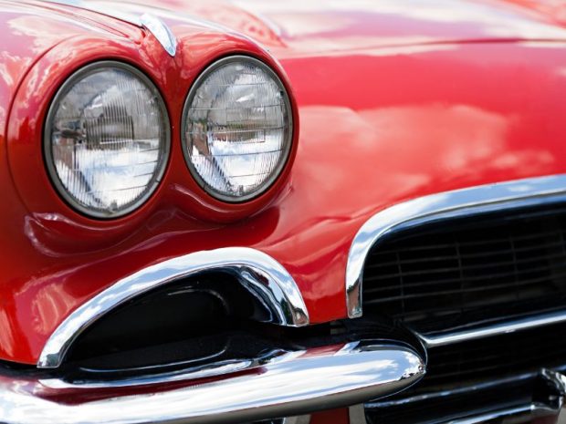 a-closeup-of-the-headlights-and-front-bumper-on-a-vintage-american